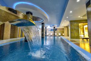 a pool in a hotel with a water fountain at Hotel Iris in Zlatibor