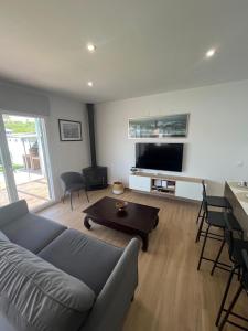 a living room with a couch and a table at Sunset Palm in El Puerto de Santa María +13 photos