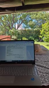 a laptop computer sitting on top of a table at Aires de campo en la ciudad in San Fernando del Valle de Catamarca
