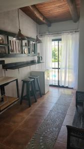 a living room with a table and a window at Aires de campo en la ciudad in San Fernando del Valle de Catamarca