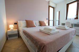 a bedroom with a bed with towels on it at Nuvole&Lenzuola in Pescara