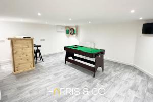 a room with a pool table and a dresser at Crews Cabin in Fleetwood