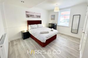 a bedroom with a large bed and a window at Crews Cabin in Fleetwood