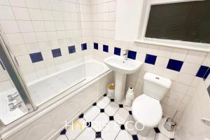 a bathroom with a white toilet and a sink at Crews Cabin in Fleetwood +15 photos