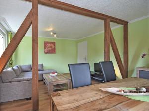 a dining room and living room with a wooden table at Entspannender Skiurlaub in Braunlage in Hohegeiß