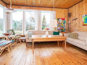 a living room with a couch and a table at 4 person holiday home in Knebel in Knebel
