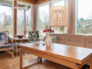 a living room with a table with a vase on it at 4 person holiday home in Knebel in Knebel +30 photos