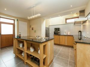 a large kitchen with a sink and a counter at Glabbeek Family Retreat Home in Bunsbeek +32 photos