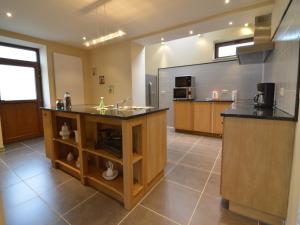 a large kitchen with a sink and a counter at Glabbeek Family Retreat Home in Bunsbeek