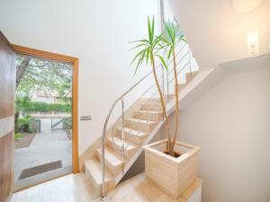 a staircase with a potted plant in a house at Villa in Alcúdia near Sandy Beach in Alcudia