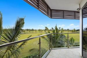 a balcony with a view of a field at Grand Lémuria by First Grand Stays - Luxury 3BR Villa with Private Pool in Bel Ombre