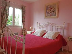 a bedroom with a bed with a red bedspread at Peaceful Valley View Villa in Cornillon