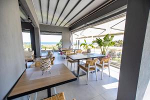 a dining room with a view of the ocean at Fyllis Fine Living Sea view in Asprovalta