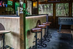 a row of stools at a bar in a restaurant at 4 Évszak Hegyihotel in Mátraháza