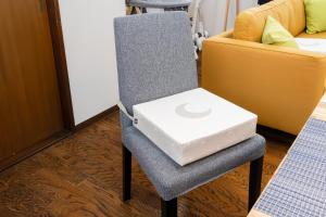 a laptop sitting on a chair in a room at HOTEL CtrlD ASAGAYA Spacious 130 Square Meter Apartment 4 Bedrooms 7 Beds 3 Minute Walk from JR Asagaya Station in Tokyo +42 photos