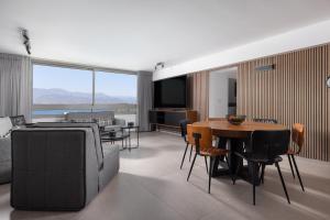 a living room with a couch and a table at Luxury Apartments And Studios At Sea Side By Rently in Eilat