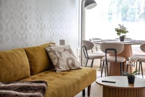 a living room with a couch and a table at Santa's City Suite by Book Lapland in Rovaniemi