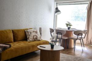 a living room with a couch and a table at Santa's City Suite by Book Lapland in Rovaniemi +10 photos