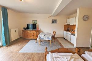 a living room with a table and a kitchen at Sunshine in Prerow