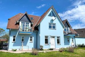 a blue house with a brown roof at Holiday-1 in Prerow