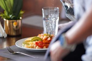 a person is taking a picture of a plate of food at The Swiss Side Iten in Iten