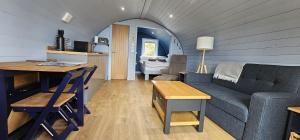 a living room with a couch and a table at Kintyre Glamping Pods in Campbeltown