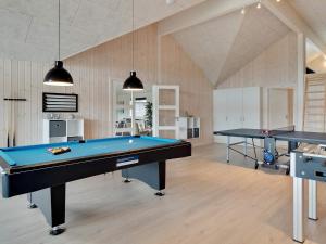 a pool room with two ping pong tables at 30 person holiday home in Nørre Nebel in Nørre Nebel