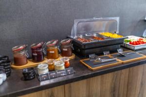 a kitchen counter with a buffet of food on a table at 4 Évszak Erdeihotel**** - Mátrafüred in Mátrafüred