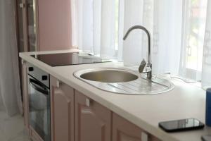 a kitchen counter with a sink and a window at Flori House in Deva +41 photos