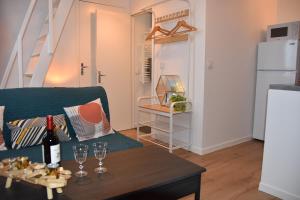 a living room with a couch and a table with wine glasses at Studio Castéra 2 Air-conditioned in Bègles