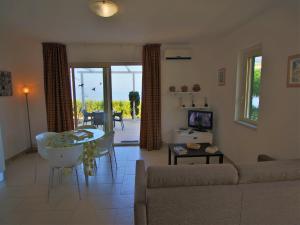 a living room with a couch and a table at Family Sea-View Retreat in Parghelia in Parghelia +26 photos