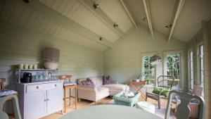 a living room with a couch and a table at East Lodge, Bughtrig in Coldstream