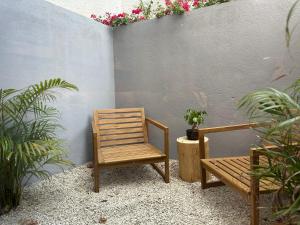 a chair and a bench in a courtyard with plants at Casa Alegria in Oeiras