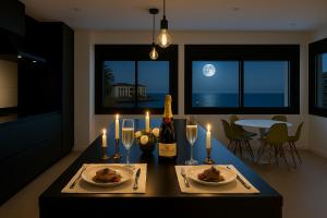 ein Tisch mit zwei Tellern Essen und einer Flasche Wein in der Unterkunft Apartamento en Ametlla de Mar SEA VIEW HAUS FREE WIFI in L'Ametlla de Mar + 35 Fotos