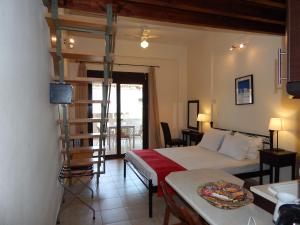 a bedroom with a bunk bed and a ladder at Kripis Studio in Pefkohori