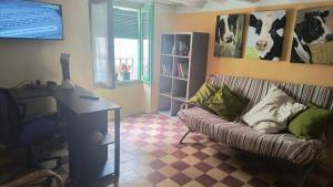 a living room with a couch and a desk at Casa Jacobin in Ayerbe