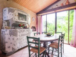 a kitchen with a table and chairs in a room at Peaceful Villa in Saint-Jory in Nanthiat