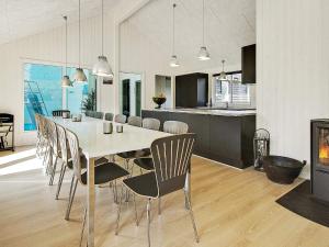 a dining room and kitchen with a table and chairs at 5 star holiday home in Liseleje in Liseleje +43 photos
