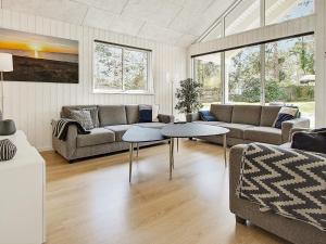 a living room with a couch and two tables at 5 star holiday home in Liseleje in Liseleje