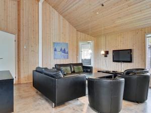 a living room with leather furniture and a flat screen tv at Luxury Retreat with Pool - By Traum Ferienwohnungen in Høruphav +19 photos