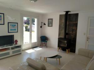 a living room with a couch and a fireplace at Beachside Brittany Escape in Pénestin +33 photos
