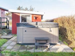 a small garage with a bench in front of a house at 6 person holiday home in Lemvig in Lemvig +22 photos