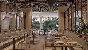 a restaurant with wooden tables and chairs and windows at Port Benidorm Hotel & Spa 4* Sup in Benidorm