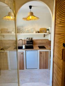 a kitchen with a sink and a counter top at Suite Myria, Balnéo & Cinéma - 1 heure de Paris in Maintenon