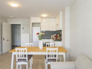 a kitchen and dining room with a table and chairs at Cubo's Marques Apartment with Free Parking in Almayate Alto