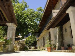 a building with potted plants on the side of it at Casa Casarellos in Casarellos