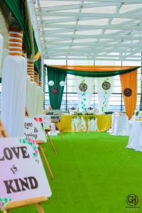 a room with a table with a sign that says love is kind at Gelian Hotel in Machakos