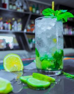 a drink with a green leaf on top of a table at Gelian Hotel in Machakos