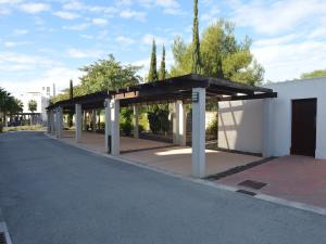 a bus stop with a pavilion on the side of a road at Golfside Luxury at Las Colinas in Orihuela Costa