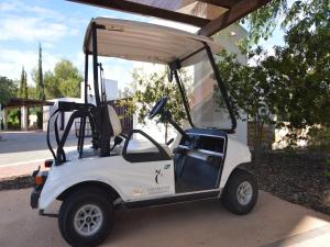 a golf cart parked in front of a building at Golfside Luxury at Las Colinas in Orihuela Costa
